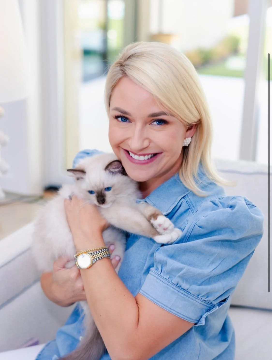 An adopter holding a young blue-point Ragdoll